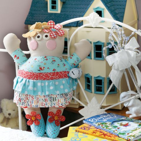 Styled shot of bluebell doll in child's bedroom with flowers and rosey cheeks