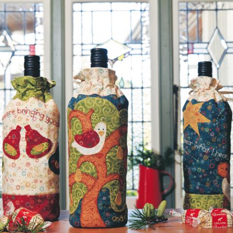 Styled shot of three different sewn Christmas themed wine bags