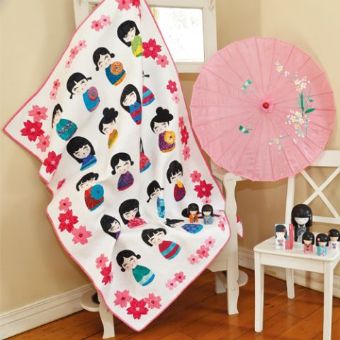 Styled shot of japanese quilt with geishas and flowers