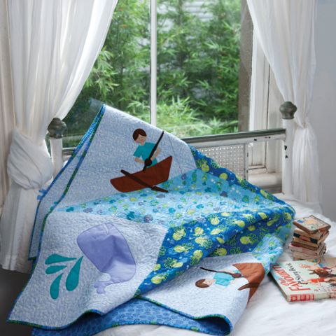 Styled shot of child's bedroom with fisherman, whale, star quilt