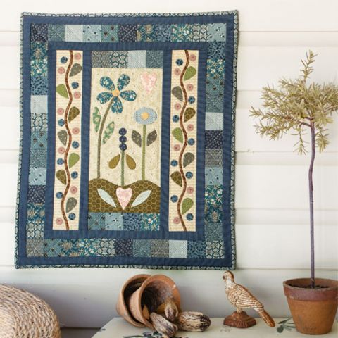 styled shot of simply blue appliqué wallhanging