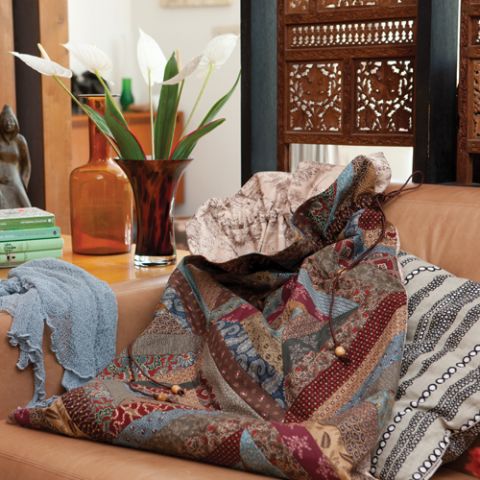 Styled shot of large patterned string piece quilt bag on lounge in living room